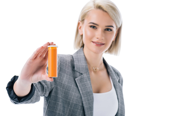 attractive blonde businesswoman holding vitamins, isolated on white - Foto, afbeelding