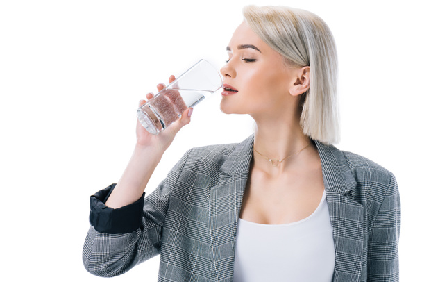 beautiful stylish businesswoman drinking water, isolated on white - 写真・画像