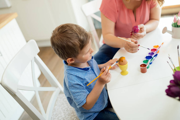Mother and son paint Easter eggs - Photo, image