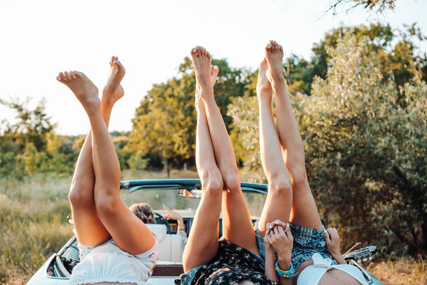 Three girls are lying on the trunk - Photo, Image
