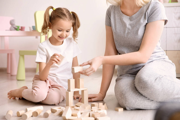 Mother and cute little girl playing with building blocks at home - Foto, imagen