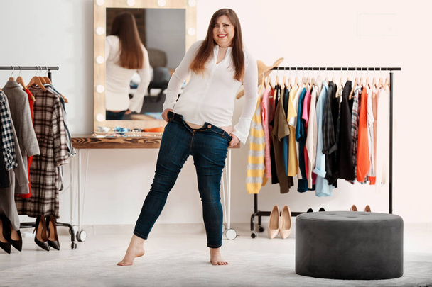 overweight woman trying on jeans - Foto, Imagen