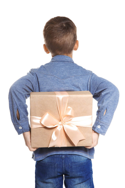 Cute little boy hiding gift for Mother's Day behind his back, on white background - 写真・画像