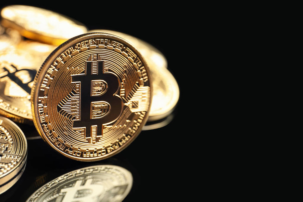 Golden bitcoins on black background - Foto, Imagen
