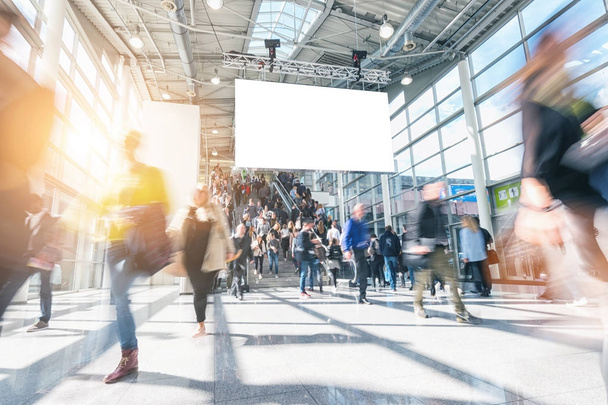 large crowd of anonymous blurred people walking at a trade show - Photo, Image