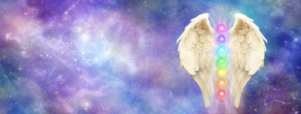 Angelic Cosmic Guardian - bright and beautiful cosmos background   with a pair of Angel Wings and seven chakras - Photo, Image