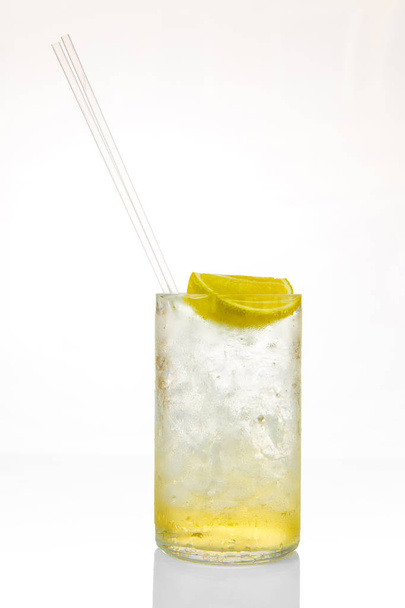 Glass of cocktail with ice and lemon isolated on white background - Foto, afbeelding