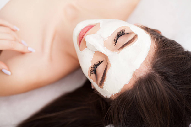 Spa therapie voor vrouw ontvangen gezichtsmasker - Foto, afbeelding