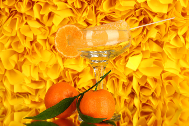 Yellow fruit juice ice in vase on decorative yellow background - Фото, изображение