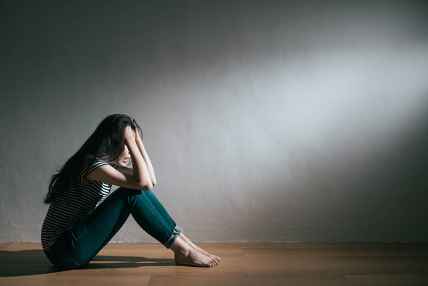woman love broken sitting on wooden floor crying - Фото, изображение