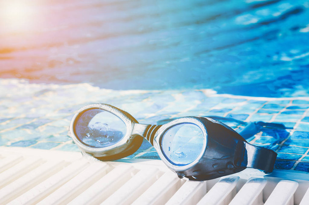 Swimming pool goggles on the poolside - Φωτογραφία, εικόνα