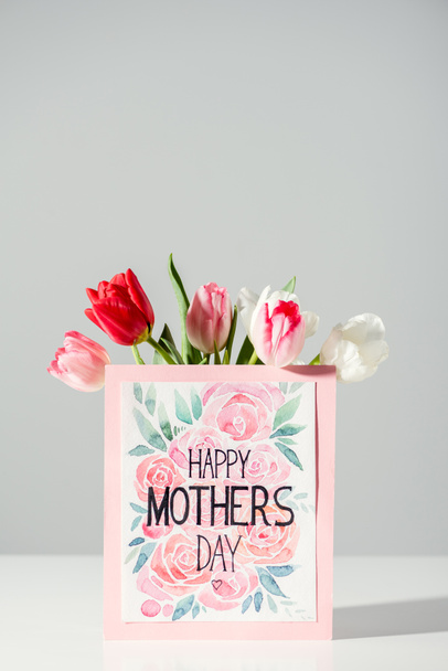 happy mothers day greeting card and beautiful blooming tulips on grey - 写真・画像