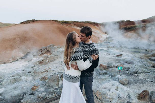 Lovely couple kissing on mountains background - Photo, Image