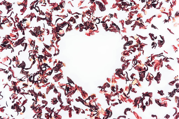 top view of heart made with hibiscus tea isolated on white, valentines day concept - Photo, Image