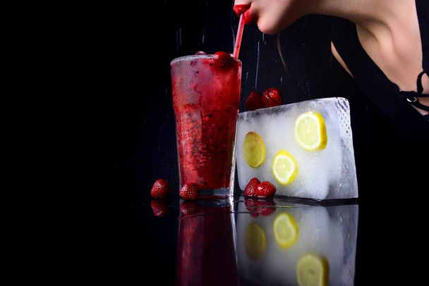 woman drink cocktail with ice cube. Bar and restaurant, lemonade. Party and summer vacation. Thirst and refresh. Cocktail with strawberry for young girl isolated on black, copy space - Zdjęcie, obraz