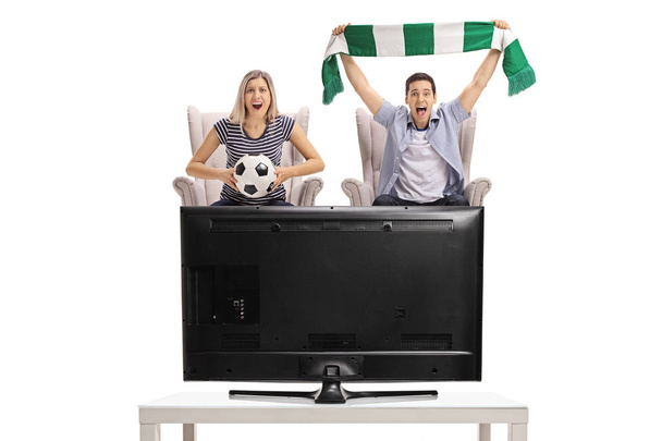 woman and man watching football on television  - Valokuva, kuva