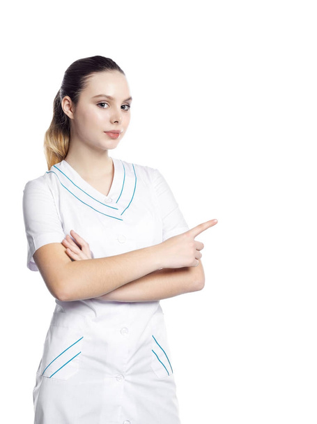 A beautiful girl in a medical robe shows. - 写真・画像