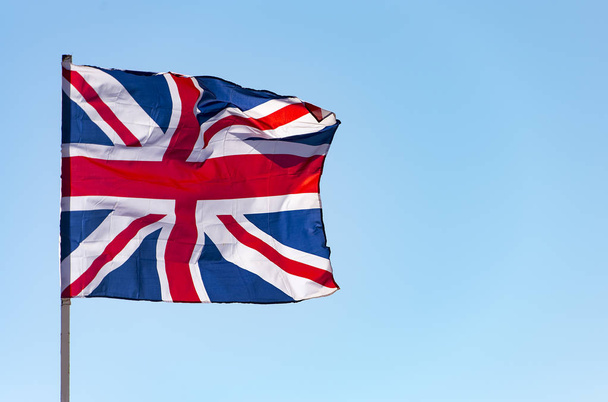 London, Great Britain flag waving against  blue sky, the British flag - Foto, Bild
