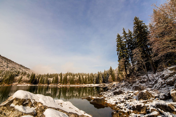 first snow at the mountain lake - Photo, Image