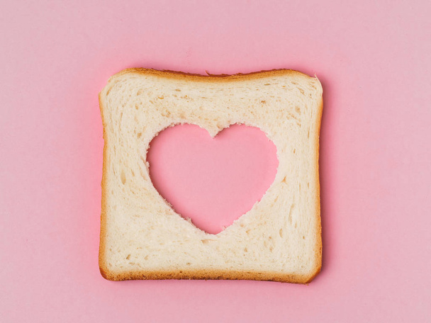 Bread with heart cut - Фото, зображення