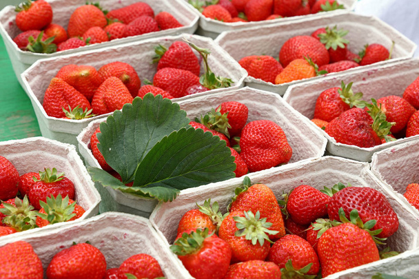 Close up strawberry in paper crates on market - Photo, Image