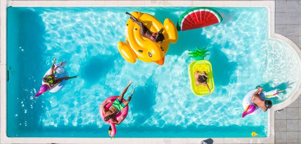 Friends having fun in a swimming pool - Foto, Bild