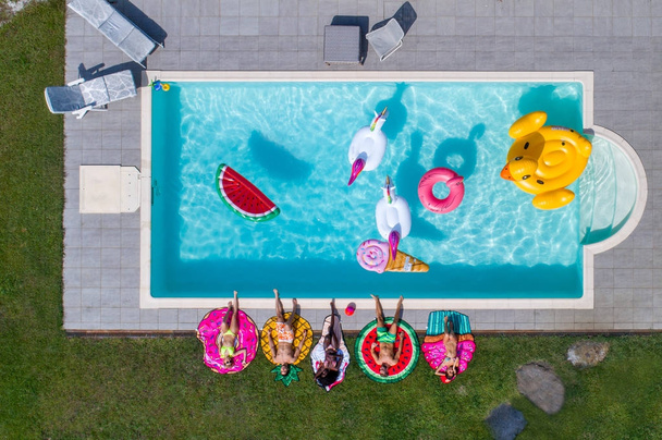 Friends having fun in a swimming pool - Valokuva, kuva