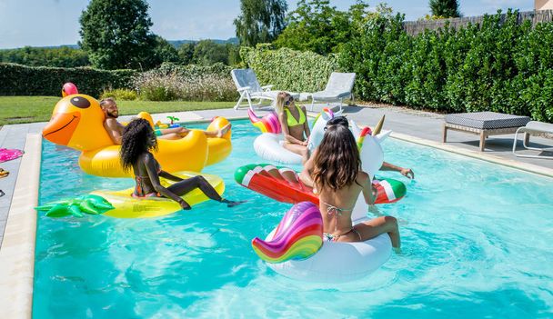 Friends having fun in a swimming pool - Fotoğraf, Görsel