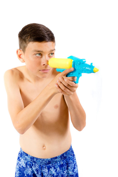 Young teenage boy playing with water guns - Fotó, kép