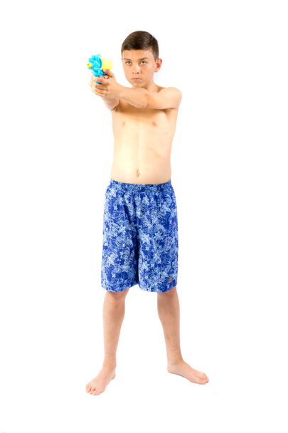 Young teenage boy playing with water guns - Fotoğraf, Görsel