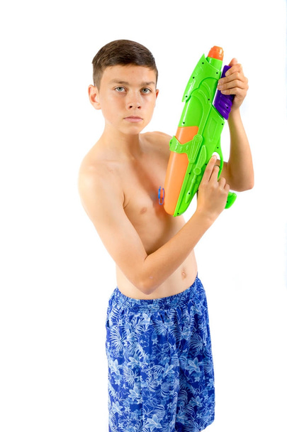Young teenage boy playing with water guns - Foto, Imagen