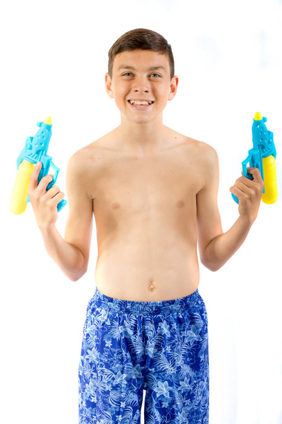 Young teenage boy playing with water guns - Foto, Bild