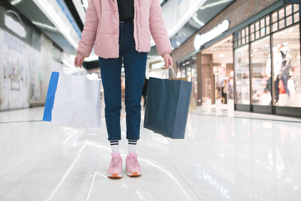 Stylish girl with shopping bags in the hands of a mall. Shopping concept. - Photo, Image