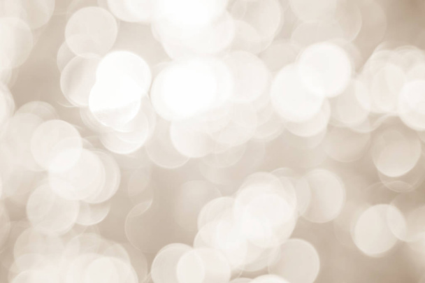 Blurred christmas snow lights on background. Design effect focus happy holiday party glow texture white wall paper bokeh sun star shiny soft plain warm flare blur night light xmas gray year. - Foto, immagini