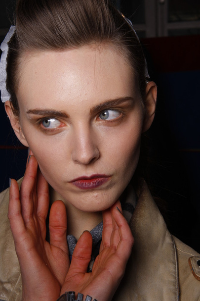 PARIS, FRANCE - MARCH 06: A model gets ready backstage at the Kenzo fashion show during Paris Fashion Week on March 6, 2011 in Paris, France. - 写真・画像