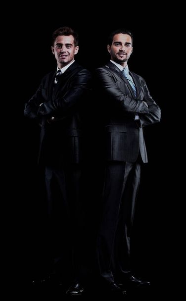 two businessmen isolated over black background. - Фото, изображение