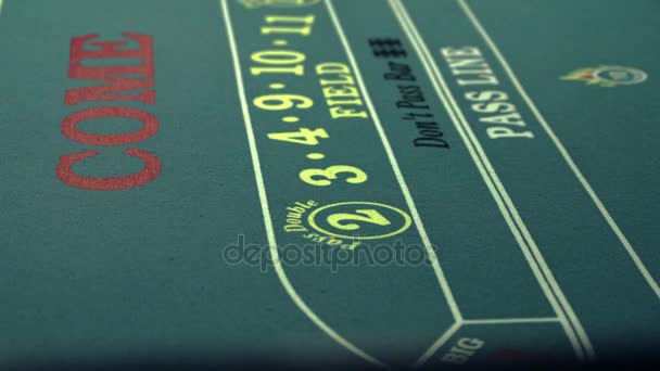 rolling dice on craps table and pushing it with stick - Footage, Video