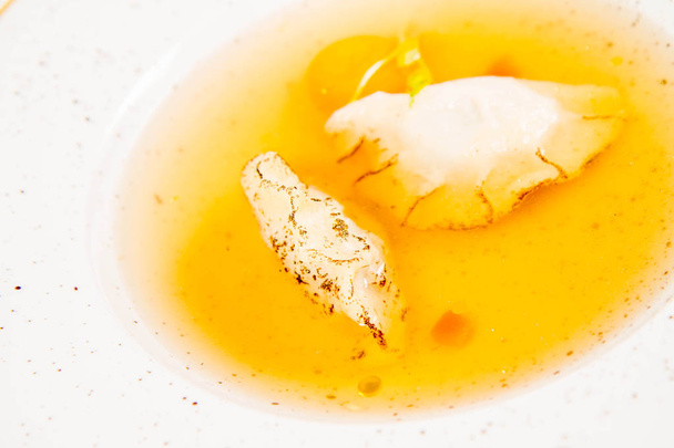 Dumplings in broth with an egg yolk on a white background - Foto, Imagen