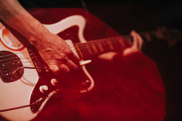 closeup rockstar on stage playing on electro guitar. Male guitarist - Φωτογραφία, εικόνα