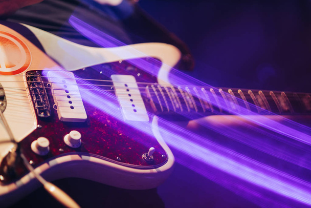 closeup rockstar on stage playing on electro guitar. Male guitarist - Foto, Imagem