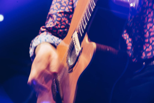 closeup rockstar on stage playing on electro guitar. Male guitarist - Φωτογραφία, εικόνα
