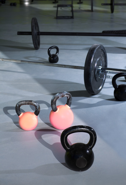 Kettlebells at crossfit gym with lifting bars - Fotó, kép