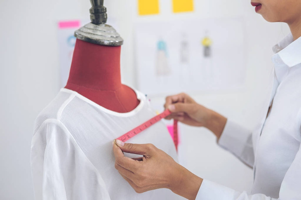 Young woman dressmaker or designer working as measuring for clot - Foto, Bild