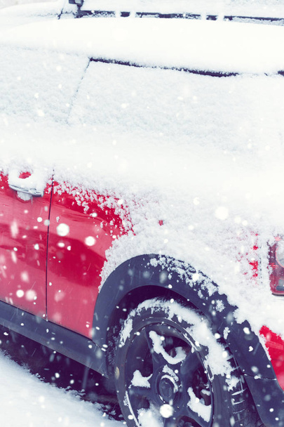 Side view of a red car covered after snowfall. Toned - Foto, Imagen