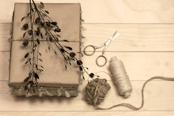 Gift box handmade from white paper, dry twigs, spruce.  - Фото, зображення