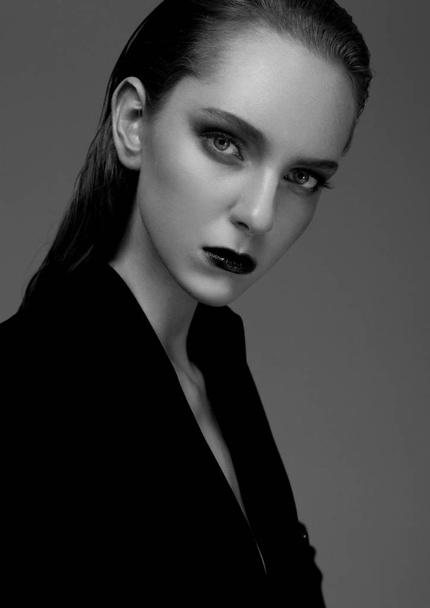 Fashion model with wet hair wearing black coat  - Valokuva, kuva