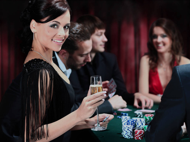 Poker players sitting around a table at a casino - Foto, Bild