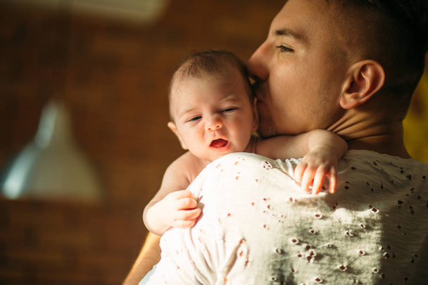 young father holding his newborn baby son - Valokuva, kuva