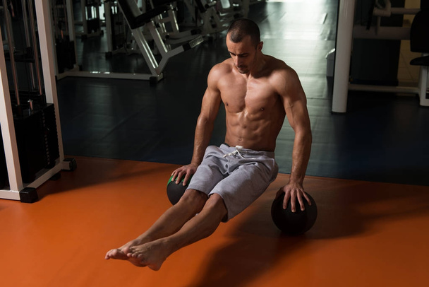 Athlete Exercising Handstand Push-Ups On Ball In Gym - Foto, Imagem