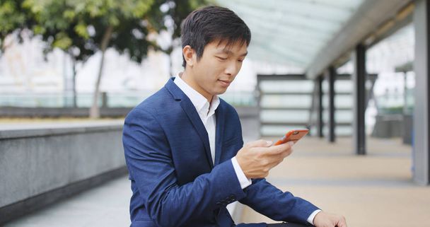 Businessman using smartphone at outdoor  - Fotó, kép